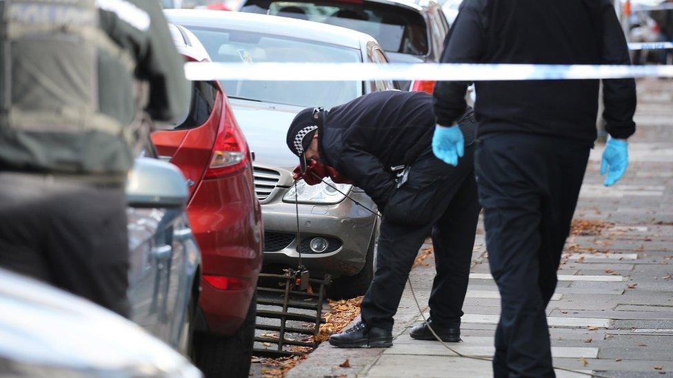 Police inspecting a drain