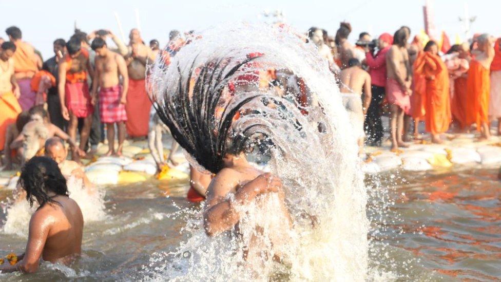 Hindu holy men taking a dip at the Sangam