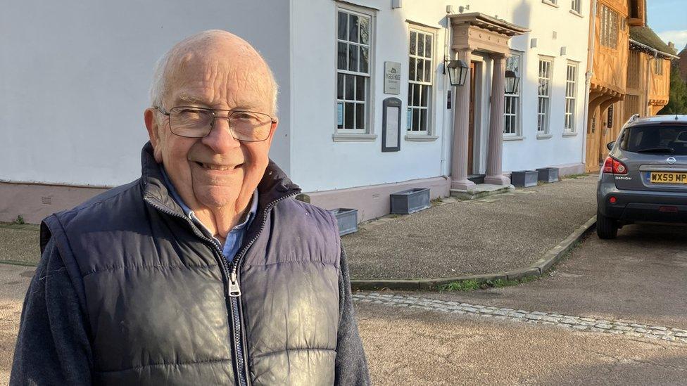 Joh Woodley, from Lavenham, wearing a coat in a village street