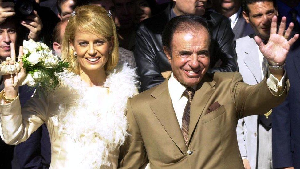 Former Argentine president Carlos Menem, 70, and his bride, the Chilean former Miss Universe Cecilia Bolocco, 36, wave following their wedding vows in a civil ceremony 26 May 2001