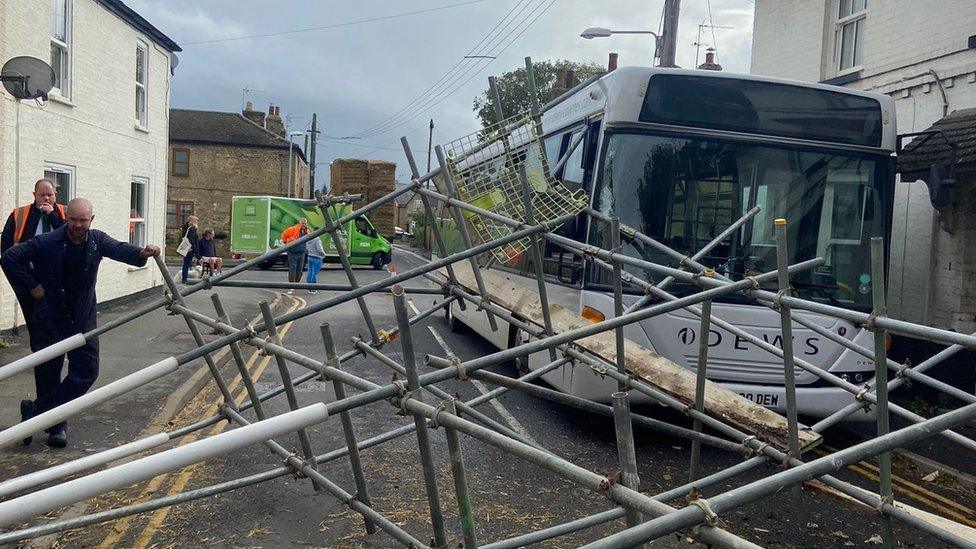 Fallen caffolding on bus and road