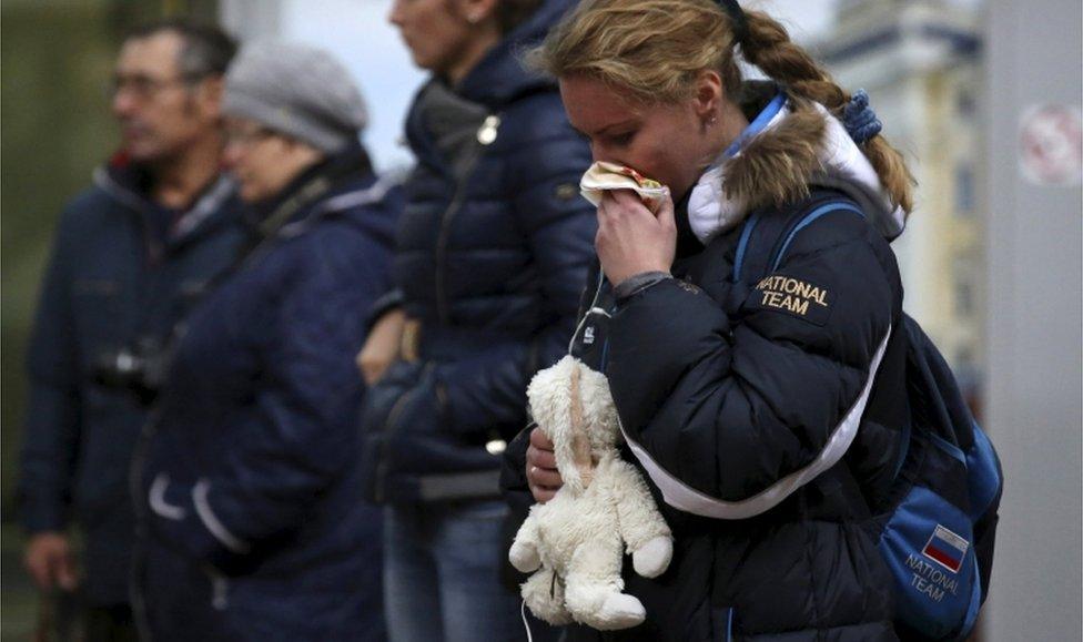 People mourn at a makeshift memorial for victims of a Russian airliner which crashed in Egypt, outside Pulkovo Airport in St Petersburg, Russia, 4 November 2015