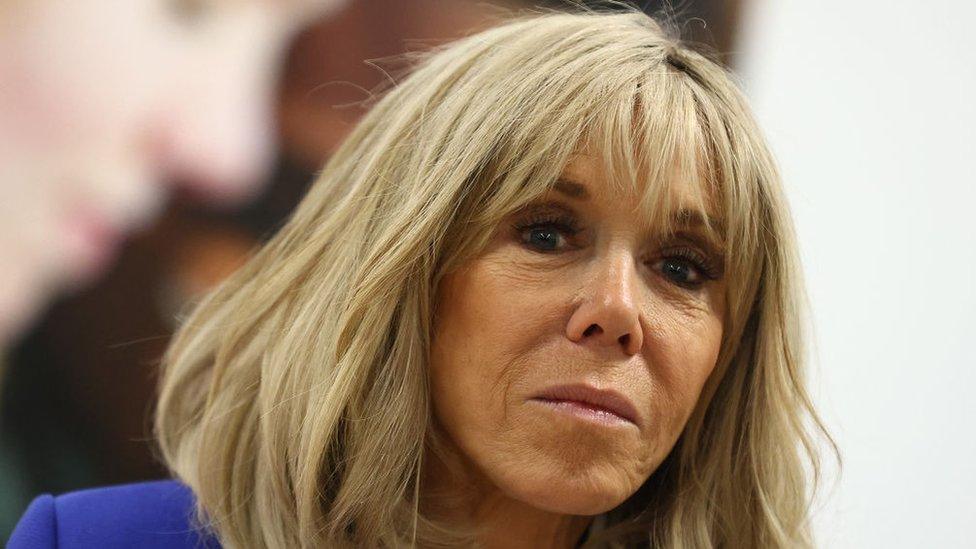 Brigitte Macron looks at the camera