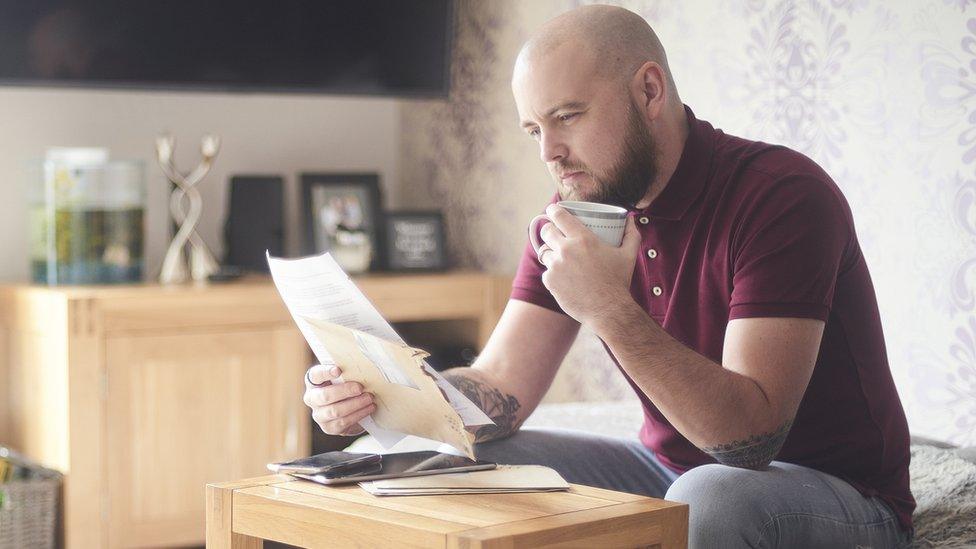 Man looking at energy bill