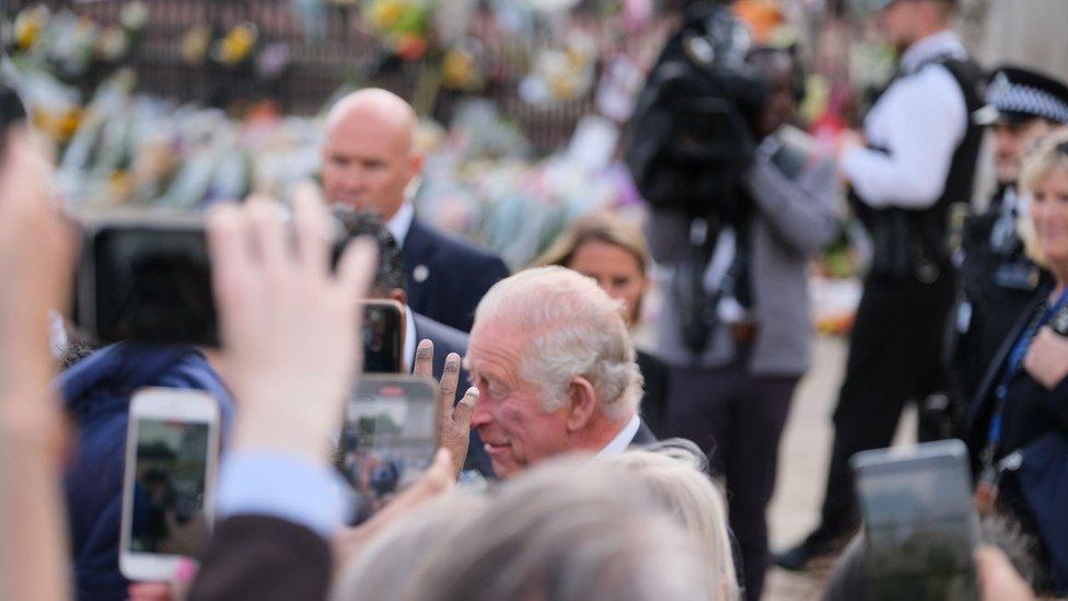 King Charles and people taking photos of him