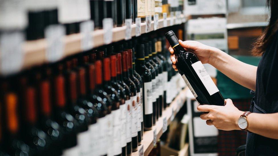 Woman choosing a bottle of wine