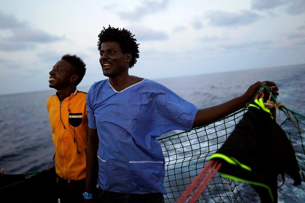 Esam (left), 22, and Ahmed, 38, both from Sudan, stand on board NGO Proactiva Open Arms rescue boat in central Mediterranean Sea