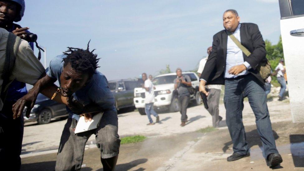 Senator Jean Marie Ralph Féthière brandishing a gun outside the Haitian parliament, Port-au-Prince (23 Sept)