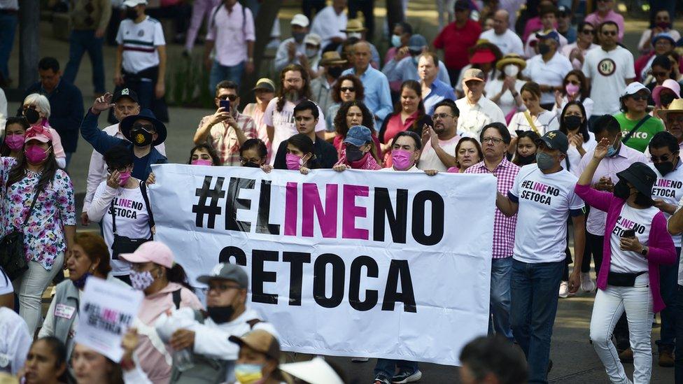 Demonstrators take part in a march against the possible government measures to restructure the National Electoral Institute (INE), in Mexico City on November 13, 2022.