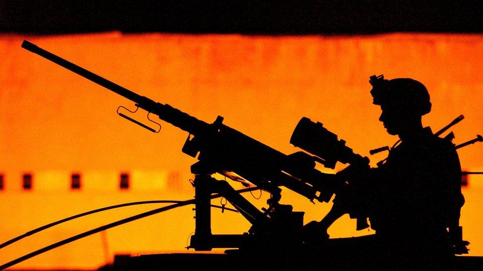 A soldier with the US Army 101st Airborne 3-502 on a night time patrol in Mosul in July