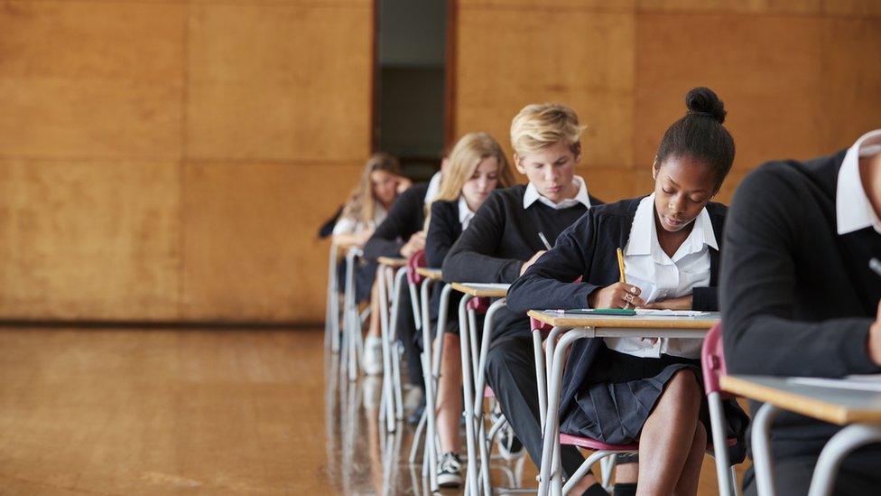 Students sitting an exam in a hall