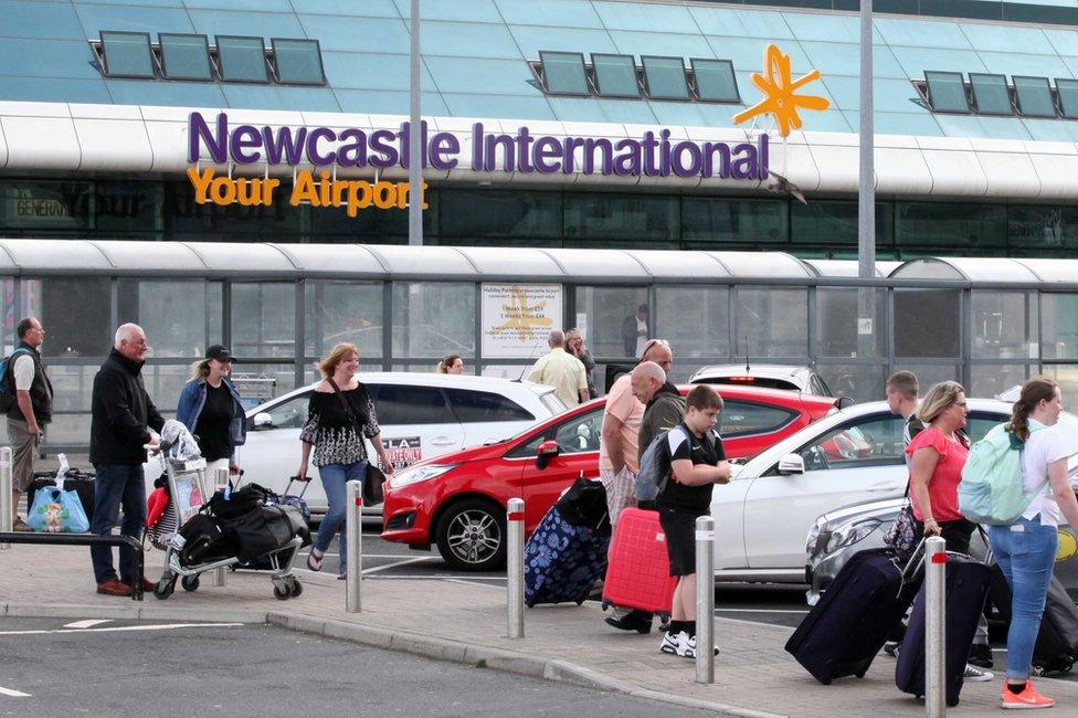 Newcastle Airport with travellers in the foreground