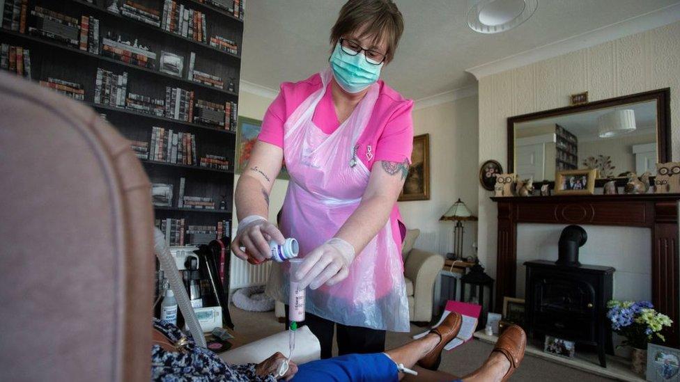 Woman care worker with a patient