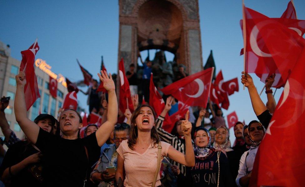 People chant slogans as they gather at a pro-government rally in central Istanbul"s Taksim square, Saturday, July 16, 2016.