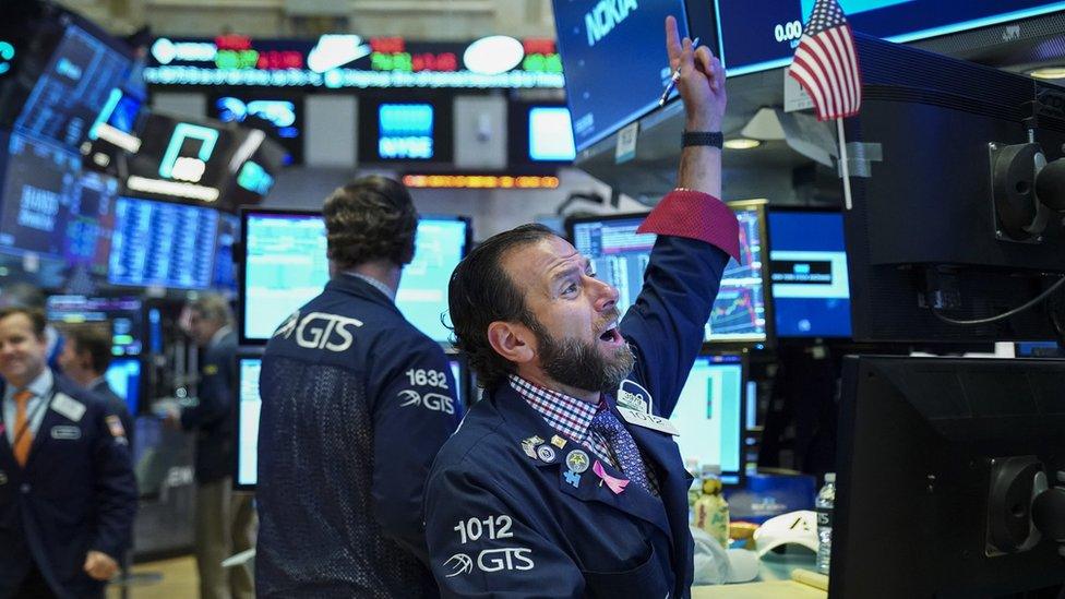 Traders and financial professionals work at the opening bell on the floor of the New York Stock Exchange (NYSE), October 12, 2018 in New York City.