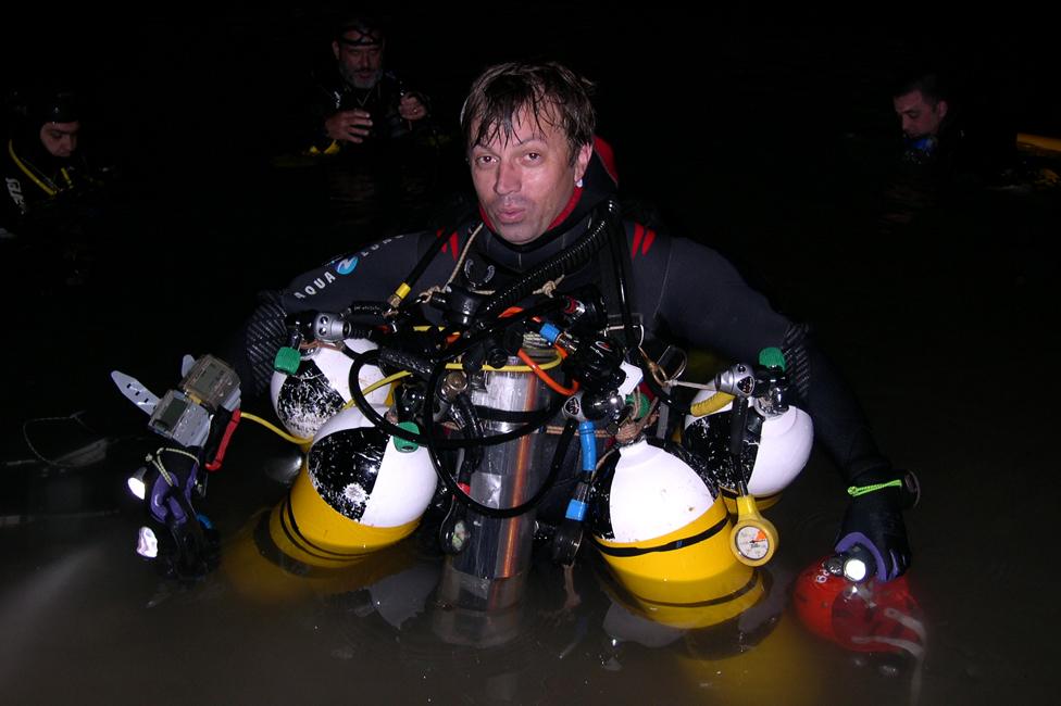 Xisco Gracias wearing his diving gear, including four tanks of air