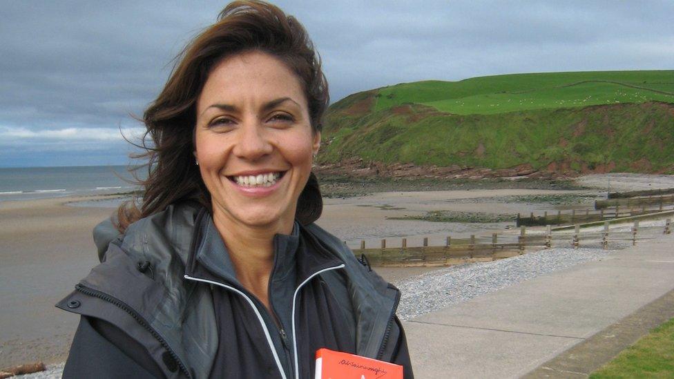 Julia Bradbury hols Wainwright coast to coast book at St Bees beach