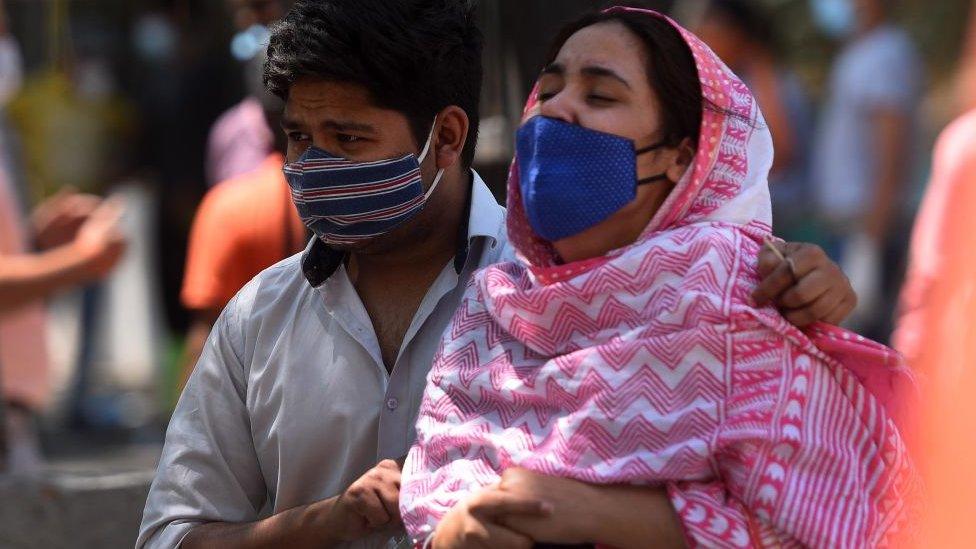 Family members consoling to each other after they lost their relative at LNJP hospital, on April 24, 2021 in New Delhi, India