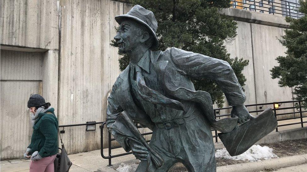 A statue called The Commuter stands outside Wheaton station, Maryland, US