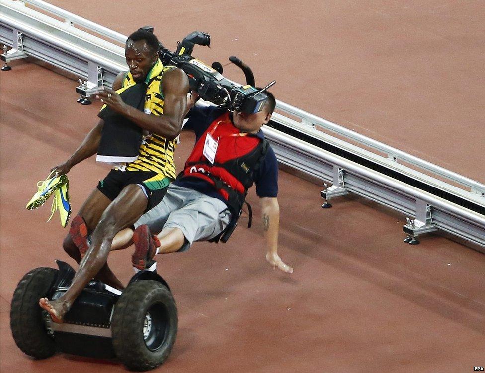 A TV cameraman drives into Usain Bolt of Jamaica after the men"s 200m final during the Beijing 2015 IAAF World Championships at the National Stadium, also known as Bird"s Nest, in Beijing, China, 27 August 2015.