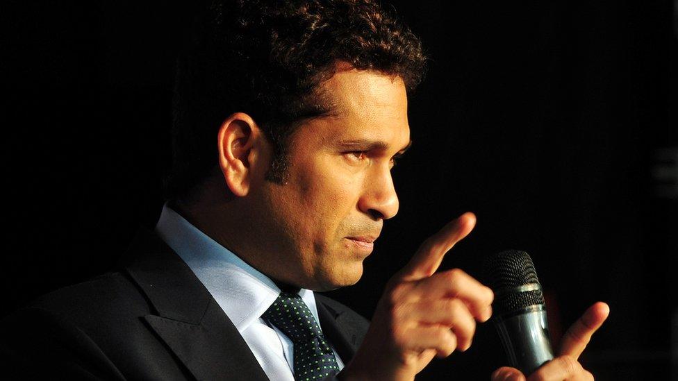 Sachin Tendulkar gestures at an event