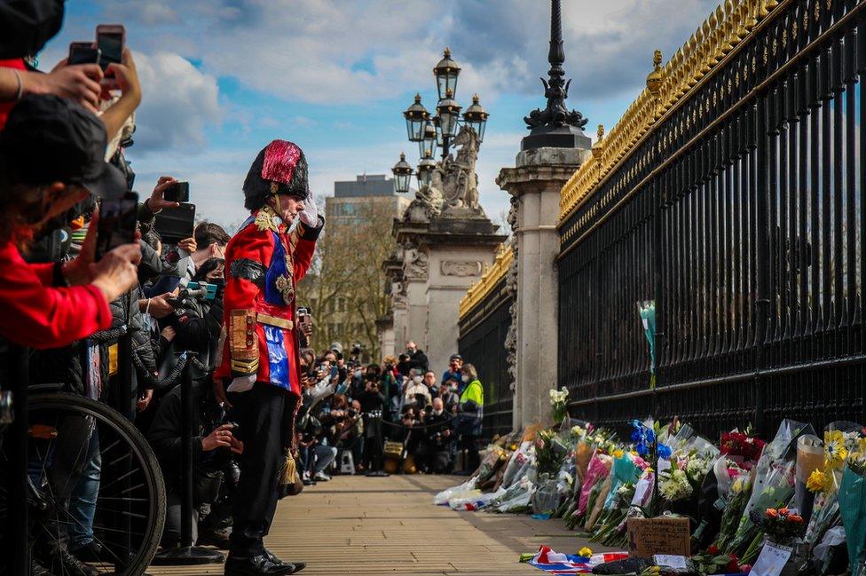 Mourners lay flowers outside Buckingham Palace following the announcement of the death of The Prince Phillip, Duke of Edinburgh