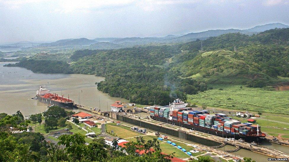 Ships pass through the Panama Canal's Pedro Miguel locks