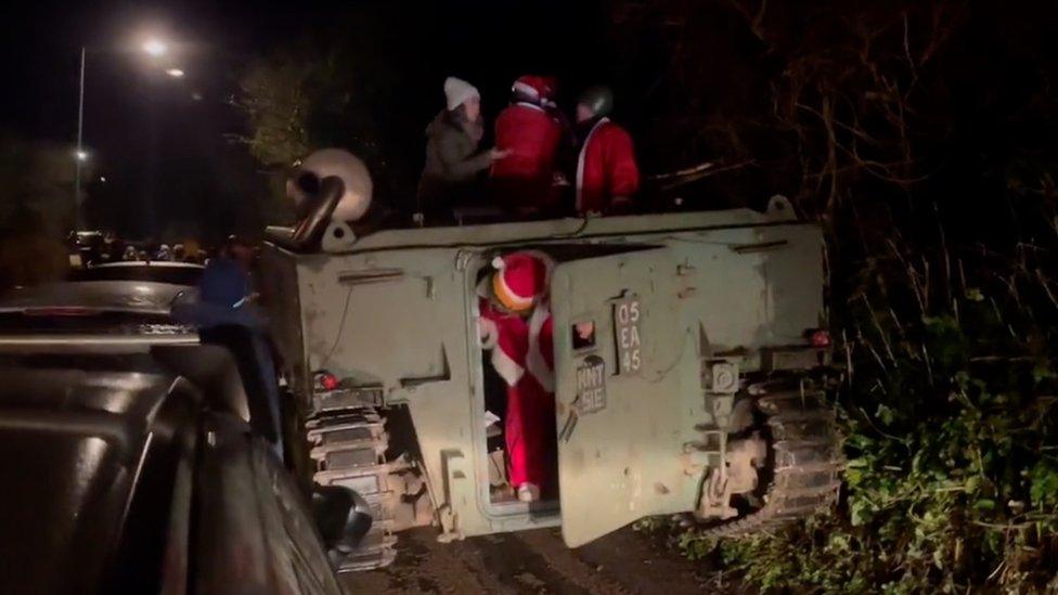 Personnel carrier filled with Santas