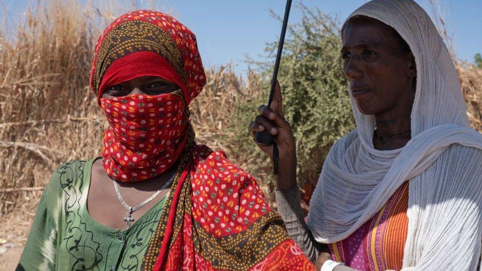 Ethiopian refugees who fled the Tigray conflict queue to register for food aid at Um Raquba reception camp in Sudan's eastern Gedaref province, on December 3, 2020