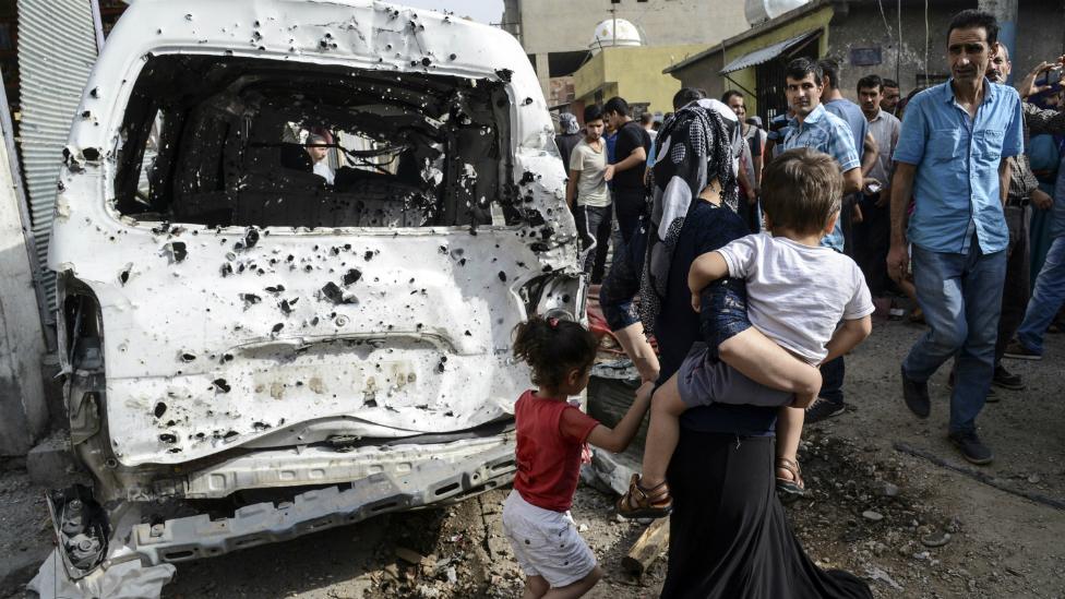 Residents walk through the centre of of Cizre in southeastern Turkey - 12 September 2015