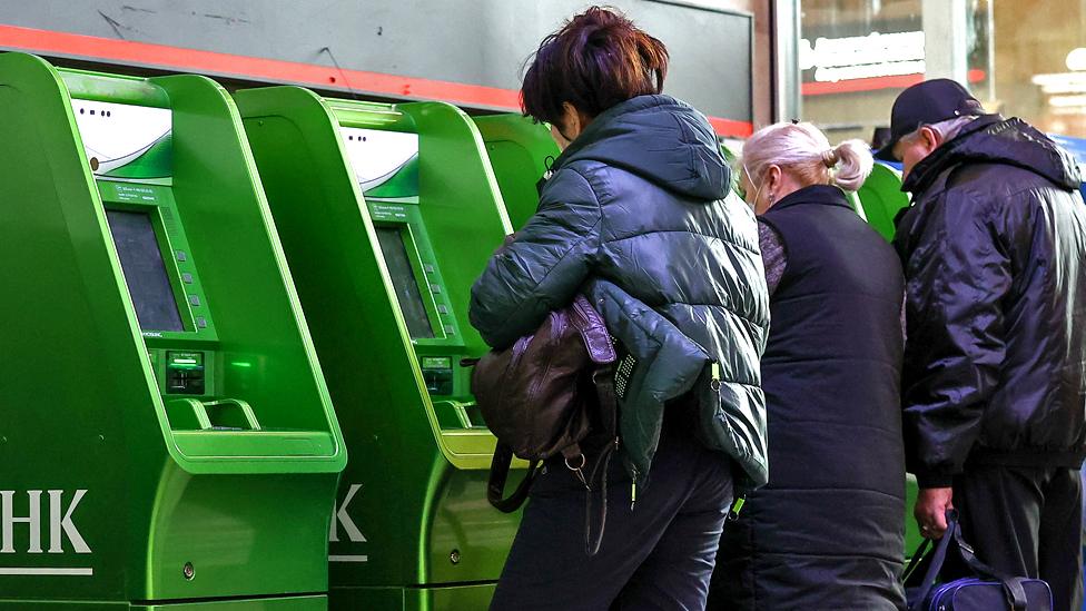 People use Sberbank ATM machines at the Kazansky railway station.