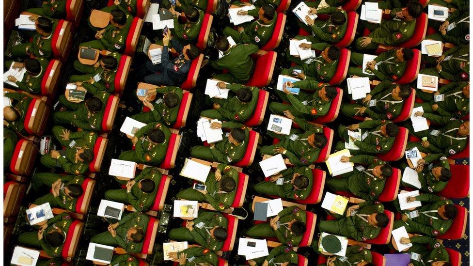 Members of the military attend the opening ceremony of the conference