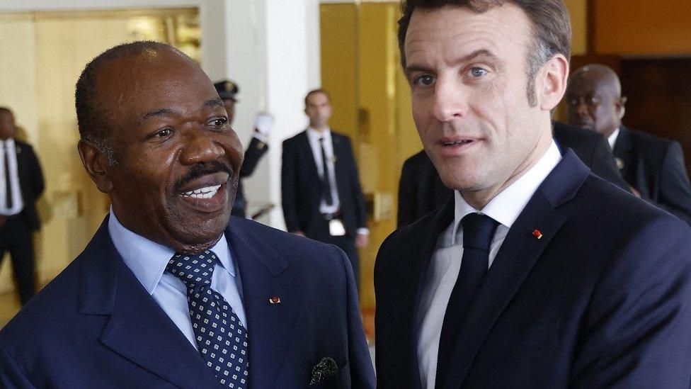 French President Emmanuel Macron (R) is welcomed by Gabon's President Ali Bongo (L)