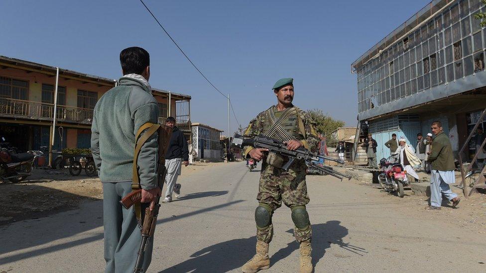 Afghan security personnel keep watch near the largest US military base in Bagram, 50 km north of Kabul, after an explosion on November 12, 2016.