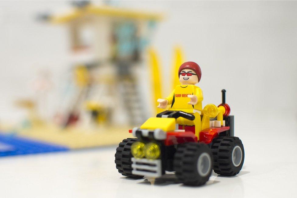 A Lego lifeguard on a quad bike. The patrol tower gives his friends a better view to protect beach-goers.