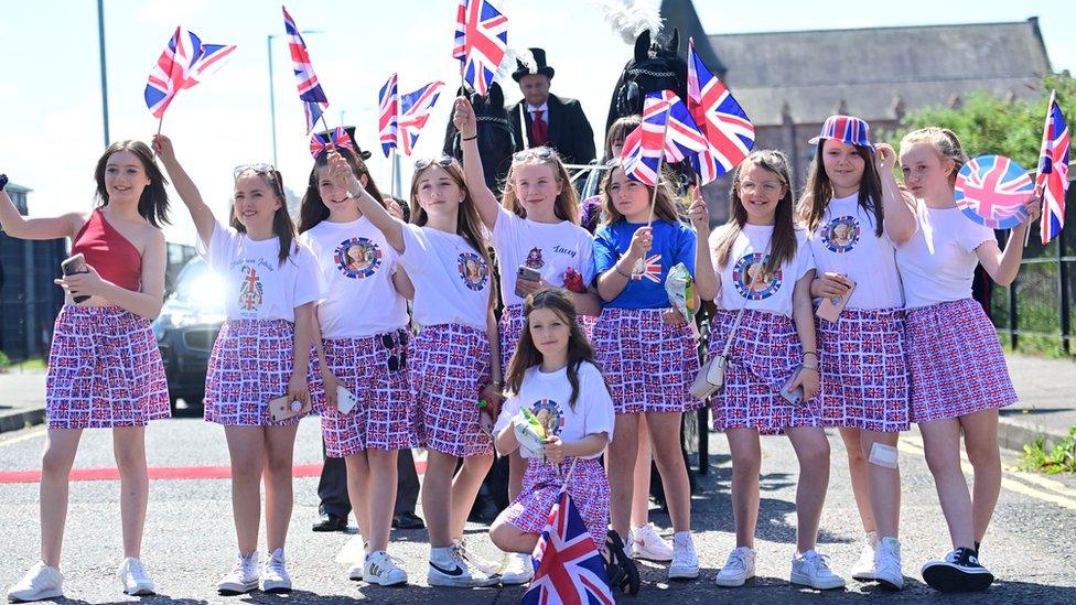 Girls waving flags on Shankill Road