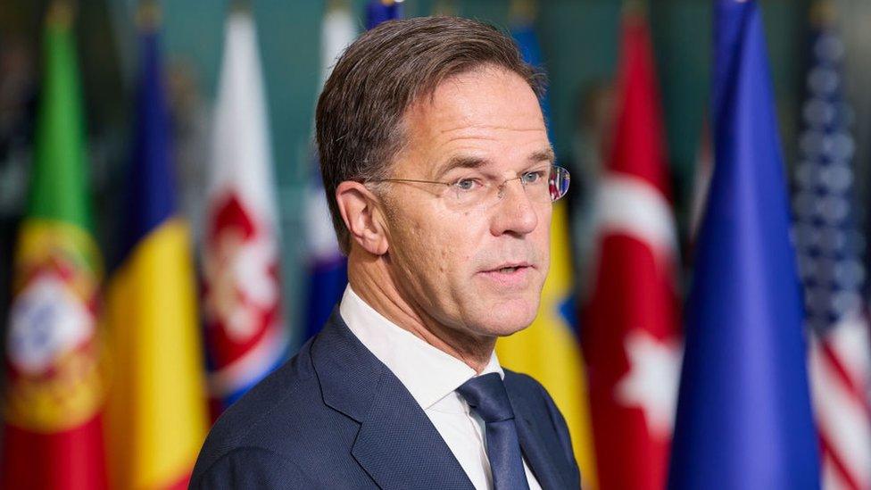 Nato secretary general Mark Rutte stands in front of member country flags at Nato headquarters in Brussels on 1 October 2024