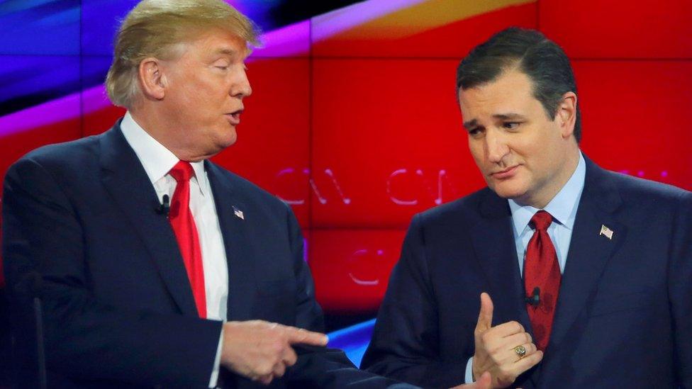 Republican U.S. presidential candidate businessman Donald Trump (L) reaches out to Senator Ted Cruz (R) as they talk during a commercial break during the Republican presidential debate in Las Vegas, Nevada December 15, 2015