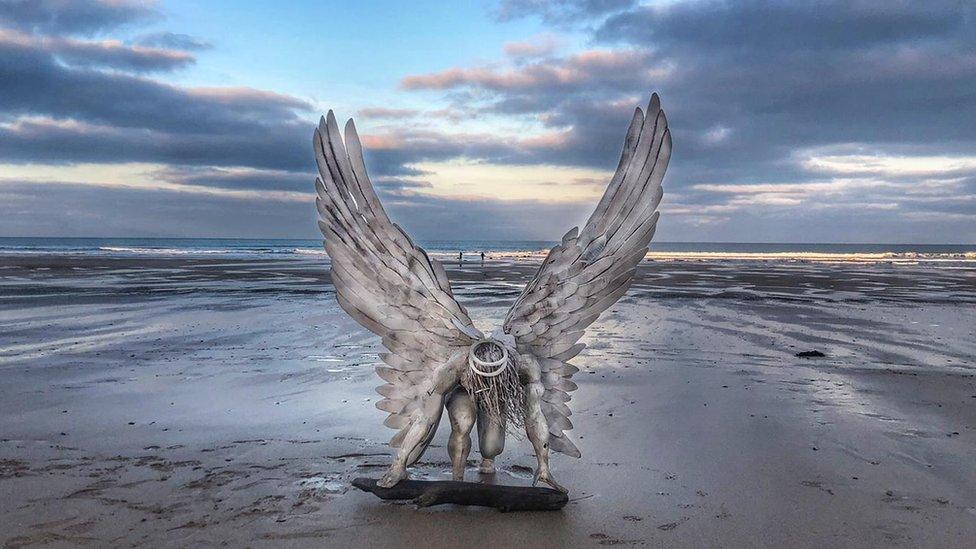 Angel statue on beach.