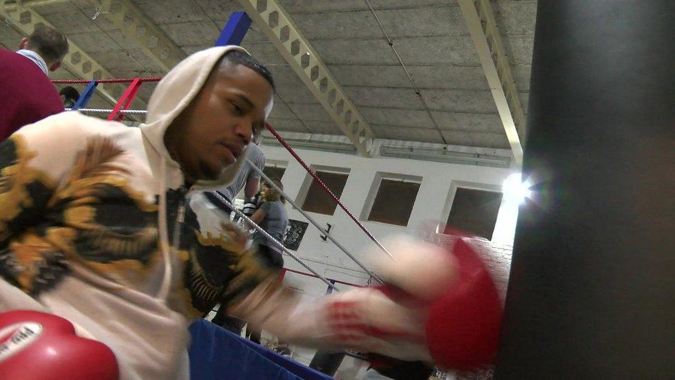 Aaron punching a bag