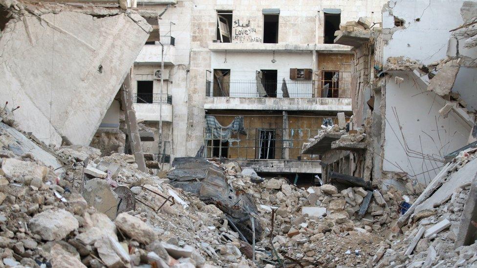 Graffiti is seen on a damaged building in Tariq al-Bab neighbourhood of Aleppo, Syria November 2, 2016