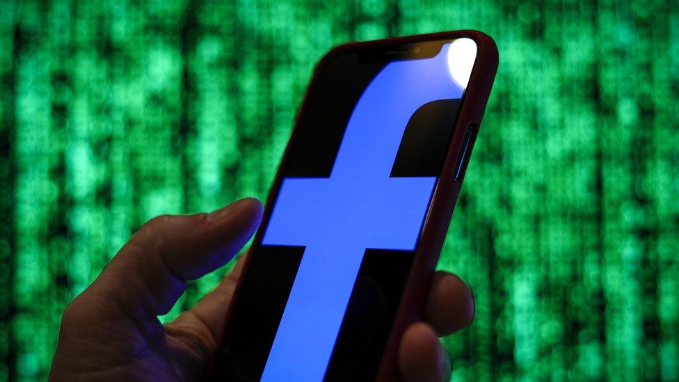 Facebook logo seen on phone screen