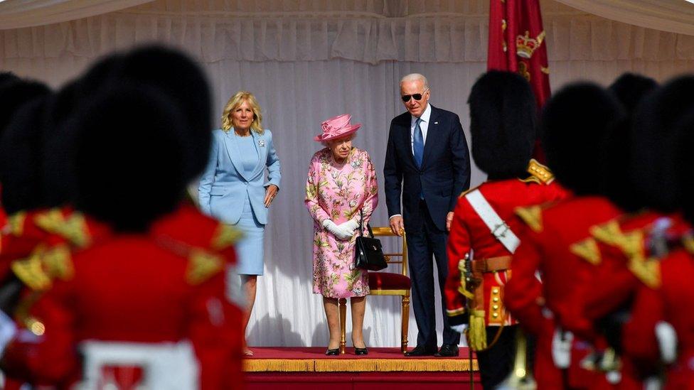 US President Joe Biden, first lady Jill Biden and Queen Elizabeth stand in front of members of the Royal Guard, at Windsor Castle on June 13, 2021