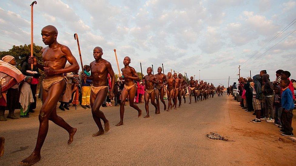 Ndebele initiates running and jumping the fire as part of the ritual during their home coming celebrations