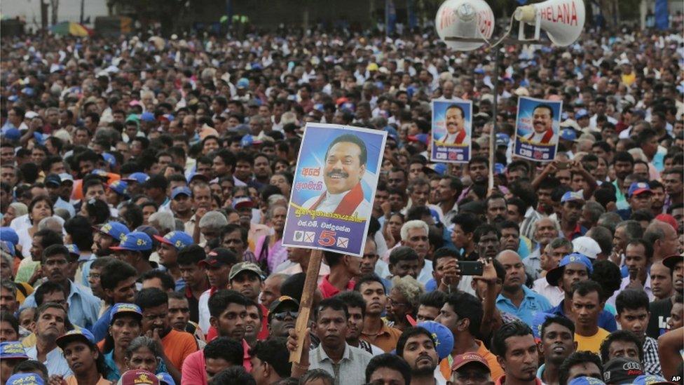 In this 17 July 2015 photo, supporters listen to Sri Lanka's former president and parliamentary candidate Mahinda Rajapaksa during an election campaign rally in Anuradhapura, Sri Lanka