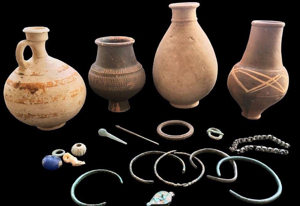 4. A selection of grave goods from the cemetery include intact pottery vessels, glass and bone beads