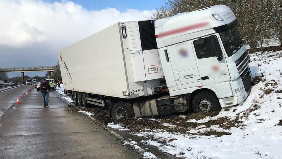 Lorry on A120 embankment in the snow