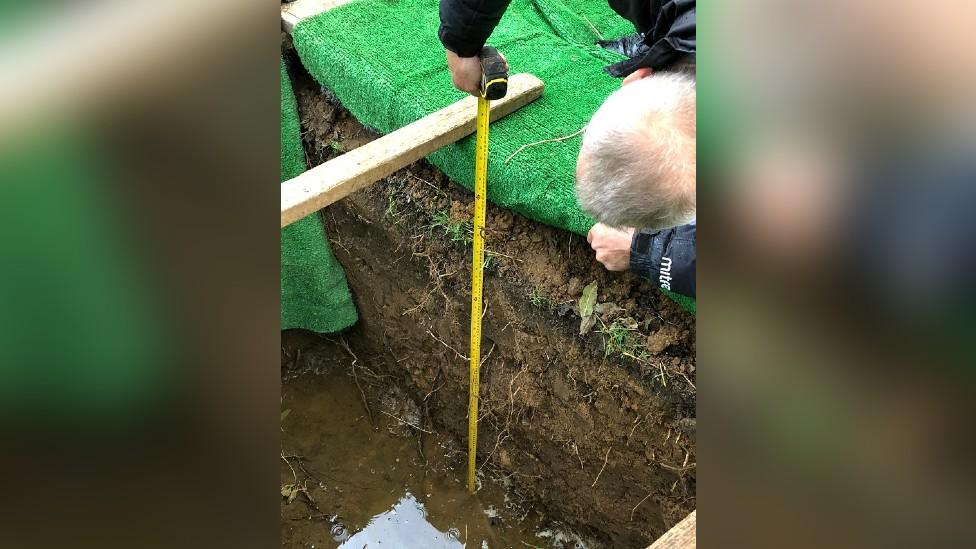 William Worby's grave being measured