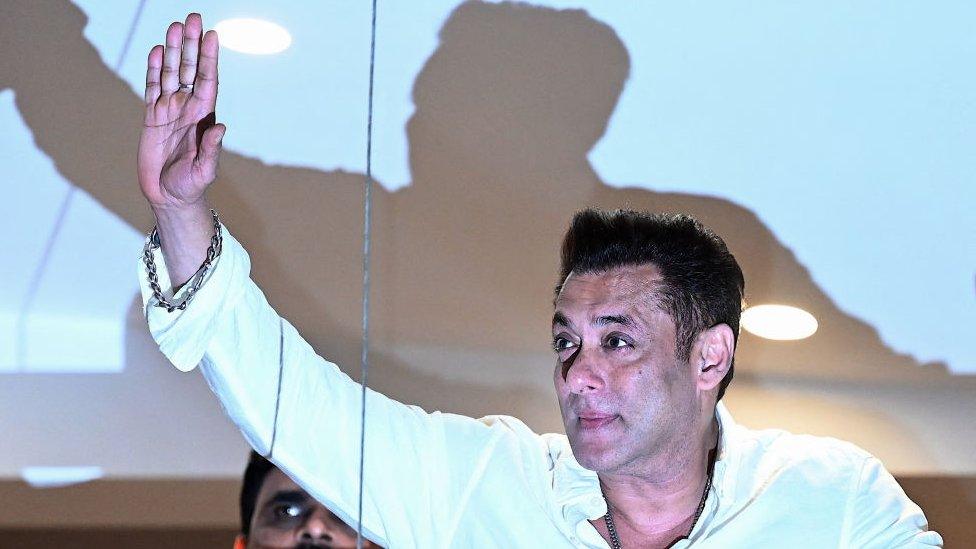 Bollywood actor Salman Khan (R) greets fans gathered outside his residence on the occasion of Eid al-Fitr, which marks the end of the Islamic holy fasting month of Ramadan in Mumbai on April 11, 2024