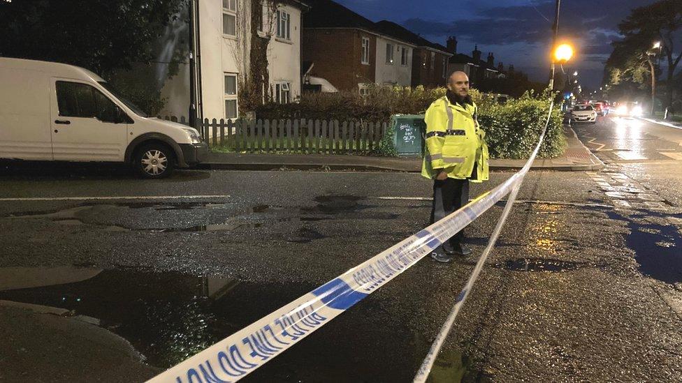 police officer standing by cordon